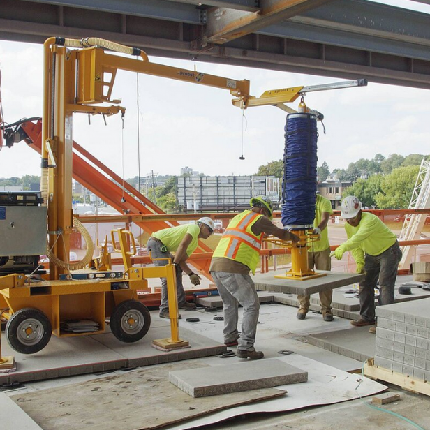 Probst Jumbomobil JM-Vario on construction site Probst JM-Vario laying slabs Probst JM-Vario with safety boom Probst JM-Vario in use with pavements